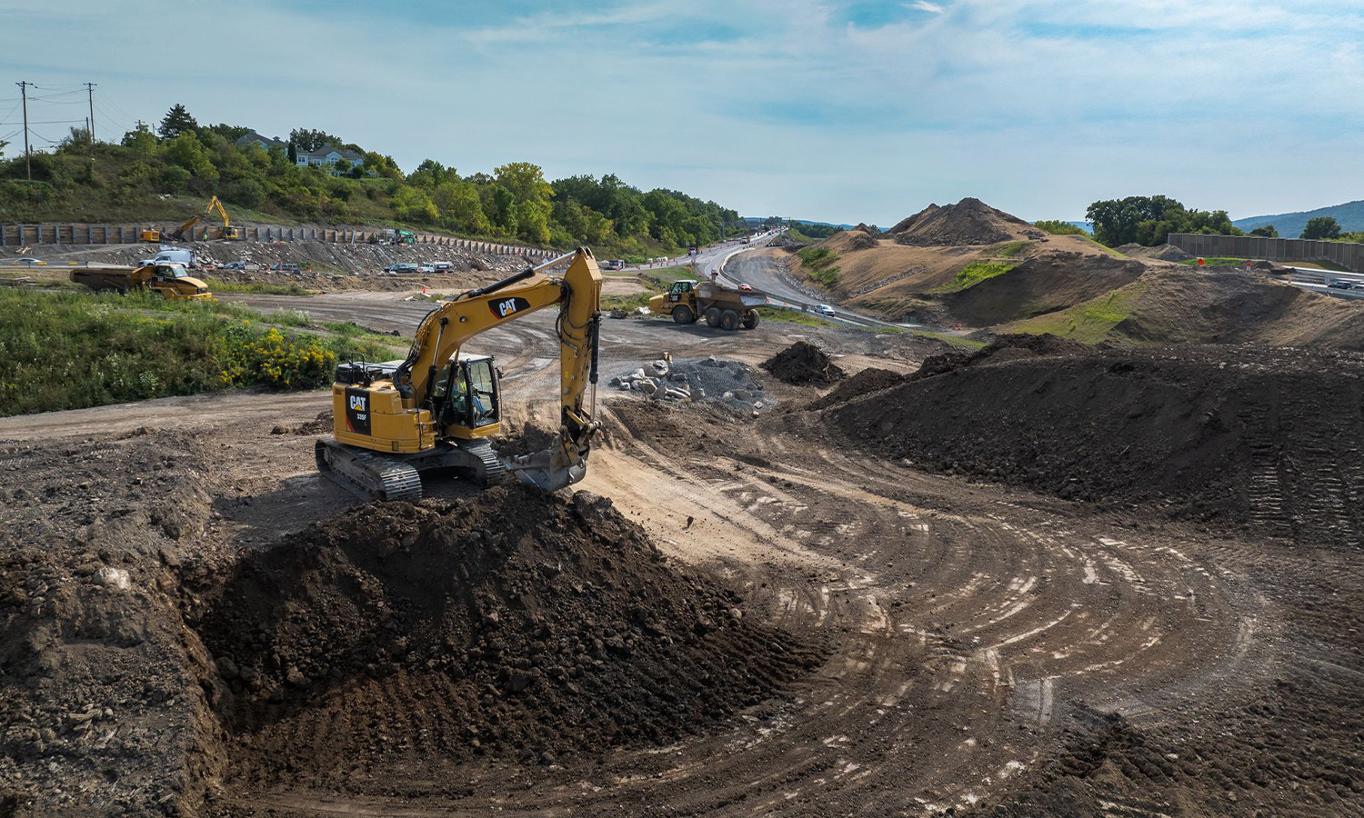 Yellow excavator moves dirt
